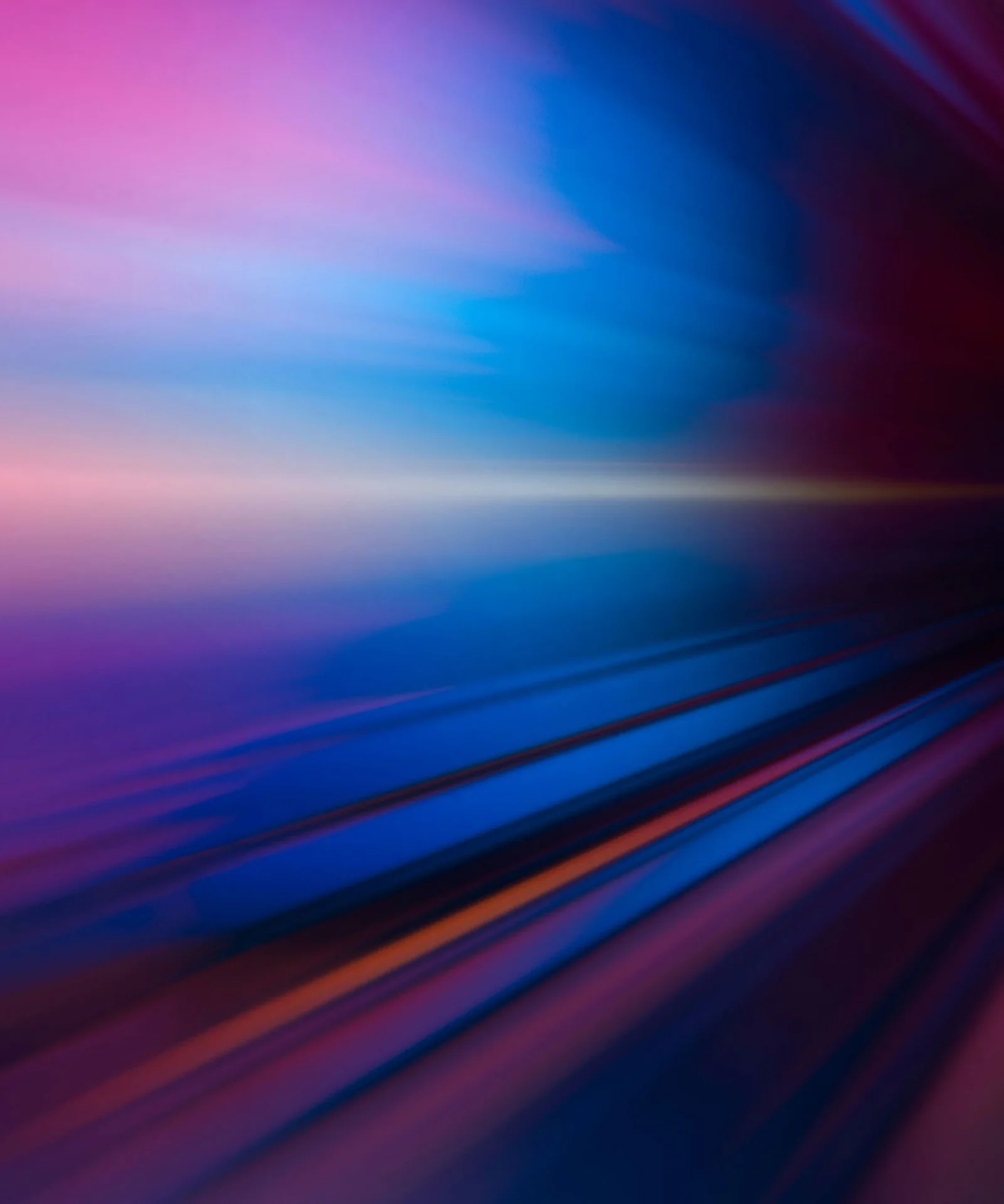 Un'immagine chiave vivace che rappresenta l'impatto dell'intelligenza artificiale, caratterizzata da un'esplosione dinamica di colori che passano dal rosa e viola al blu e giallo, senza alcun motivo di sovrapposizione. AI Impact Key Visual